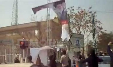 PROTESTERS TEAR DOWN A KHOMEINI POSTER WHILE ON-LOOKERS CHEER AND REJOICE ON THE 31ST ANNIVERSARY OF THE IRANIAN REVOLUTION THAT DISPOSED OF THE WESTERN MONARCHY OF IRAN. TEHRAN, IRAN. 11/02/2010