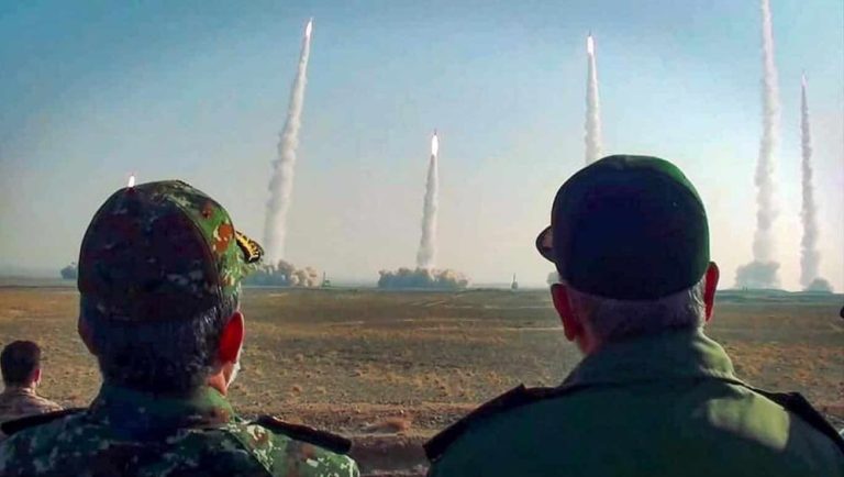IRGC commanders pose during a visit to a missile test site in Iran