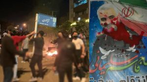 iran-uprising-street-damaging-board-soleimani-poster iran-uprising-street-damaging-board-soleimani-poster