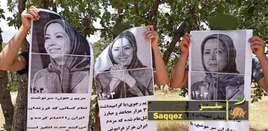 PMOI Resistance Units in Saqqez, western Iran, hold images of NCRI President-elect Maryam Rajavi in July 2024