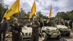 Hezbollah fighters pose with weapons and military gear supplied by Iran’s clerical regime