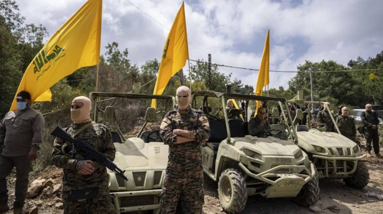 Hezbollah fighters pose with weapons and military gear supplied by Iran’s clerical regime