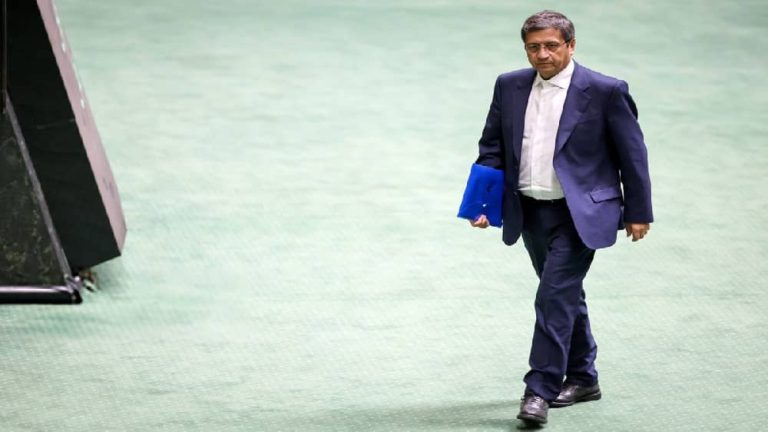 Iranian regime’s Economy Minister Abdolnaser Hemmati walks through parliament as impeachment looms