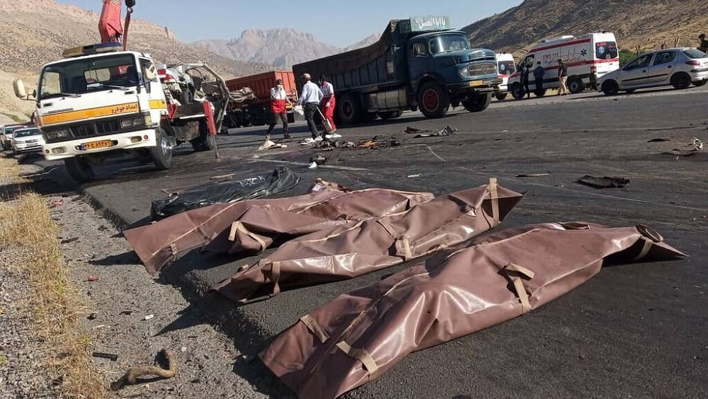 Body bags lined up along a highway in Iran following a fatal accident