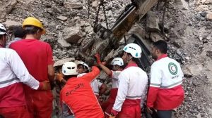Mine workers in Bajestan attempt to reach their trapped peers following a deadly rockfall inside the shaft