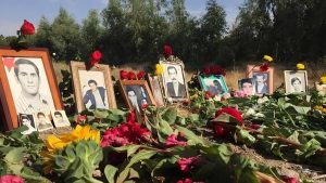 Families of 1988 massacre victims place flowers and photos at Khavaran, a site long known as the burial ground of the regime’s atrocities and fallen freedom fighters