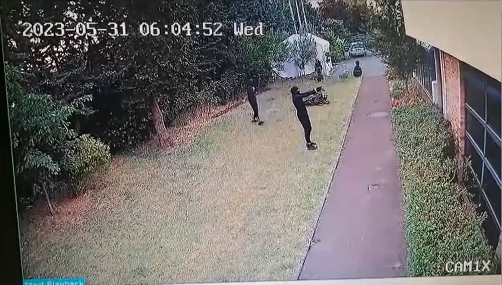 Screenshot from surveillance footage showing a masked gunman firing multiple shots at the CIMA Association building near Paris, May 31, 2025