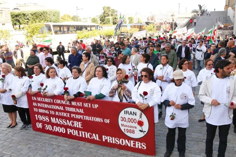 Supporters of the Iranian Resistance rally to demand justice for the victims of the 1988 massacre