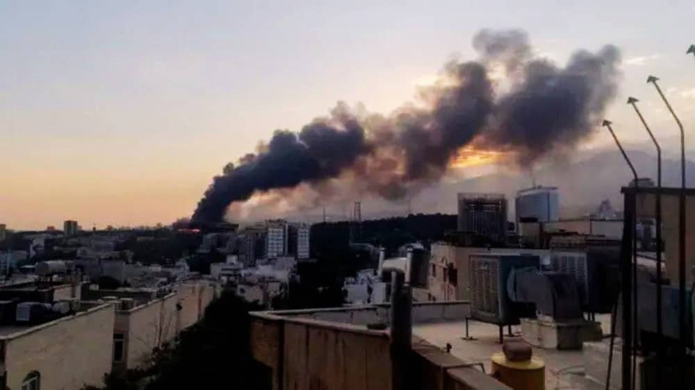 June 2025 — Smoke rises in the distance near an Iranian city, following an Israeli airstrike during the ongoing conflict