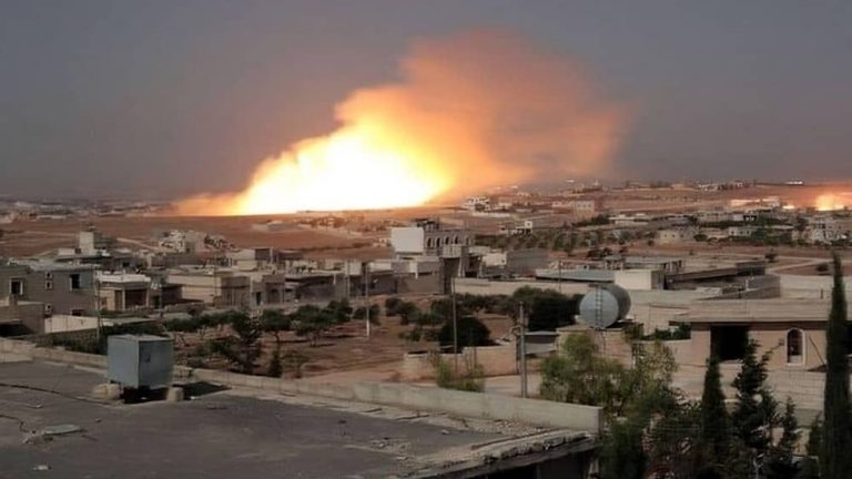 A massive explosion lights up the horizon following an airstrike in Iran, June 2025