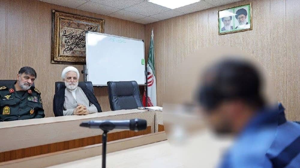 Ahmadreza Radan (left), commander of Iran’s SSF, and Judiciary Chief Gholam-Hosein Mohseni Ejei question an alleged spy during a televised interrogation aired by state media in June 2025