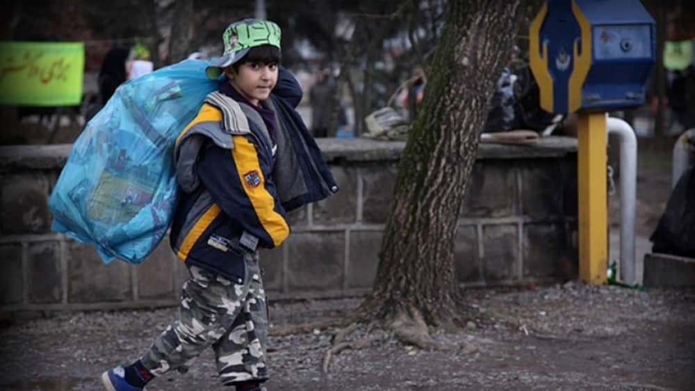 Iranian boy collecting garbage to make ends meet