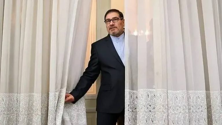 Ali Shamkhani, advisor to the Iranian regime’s Supreme Leader, looks out from behind a curtain
