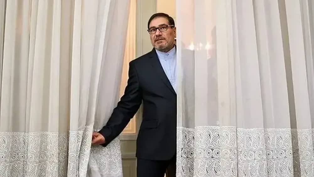 Ali Shamkhani, advisor to the Iranian regime’s Supreme Leader, looks out from behind a curtain