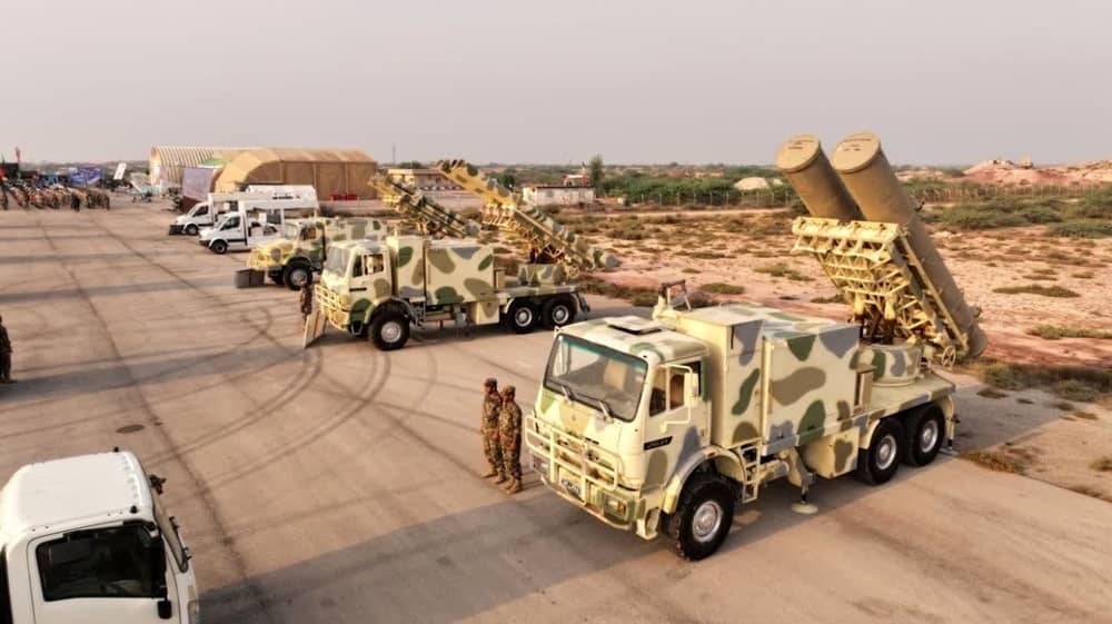 Iranian military trucks fitted with large missile launchers are seen lined up at a desert base during a display of hardware