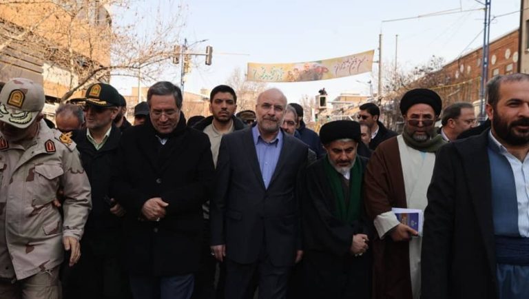 Iranian officials, including parliament speaker Mohammad Bagher Ghalibaf, march in a state-organized anniversary rally in February 11, 2026