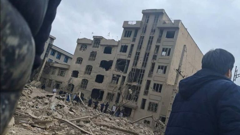 Destroyed buildings and damaged vehicles in Tehran at Bagheri Highway and Tahamtan Street after a midday bombing on March 16, 2026