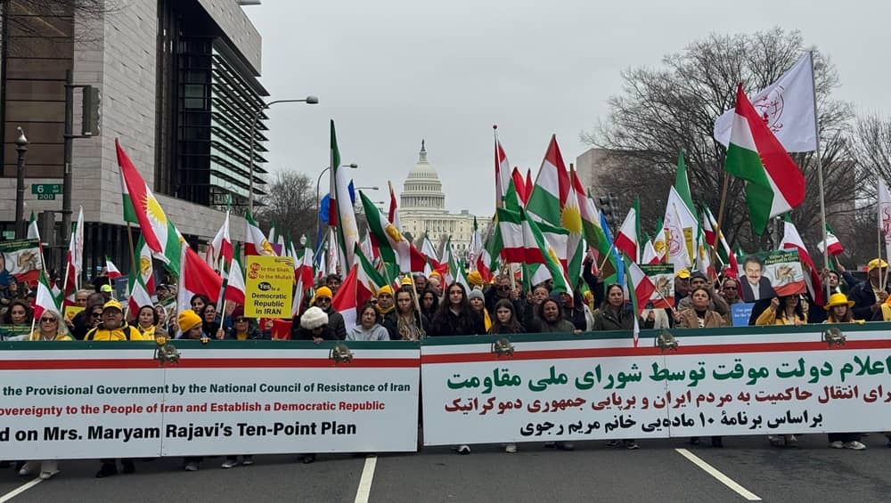 Washington, D.C., March 8, 2026: A vibrant crowd of demonstrators fills the street in a colorful display of solidarity, bringing together people of varied political leanings and ethnic backgrounds beneath a sea of flags near the U.S. Capitol