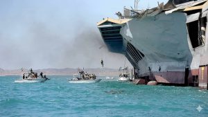 Islamic Revolutionary Guard Corps (IRGC) speedboats maneuvering around a damaged ship