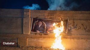 Chabahar, southeastern Iran – A large portrait of the slain Supreme Leader Ali Khamenei burns during a fiery protest operation by PMOI/MEK Resistance Units,
