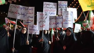 Regime-aligned protesters rally against US negotiations, with one sign reading: "Had we assassinated Trump, the U.S. would seek negotiations with us"— June 2026