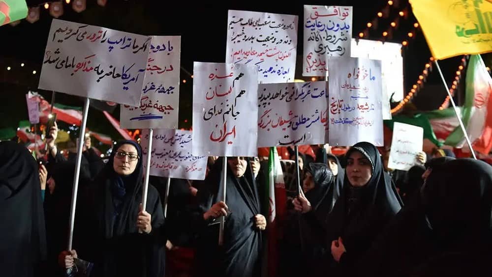 Regime-aligned protesters rally against US negotiations, with one sign reading: "Had we assassinated Trump, the U.S. would seek negotiations with us"— June 2026