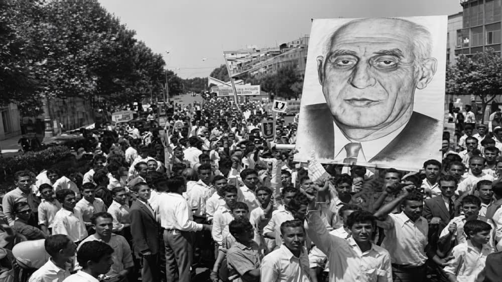 July 21, 1952—Massive crowds in Tehran, Iran's capital, carry a large portrait of Prime Minister Mohammad Mossadegh during the 30 Tir uprising