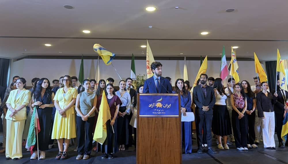 Representatives of Iranian youth communities take the stage at a meeting in Rome on July 18, 2026