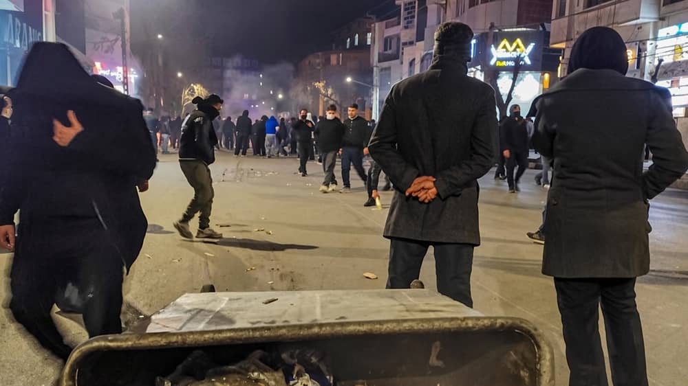 Protesters stand on a nighttime city street in Iran during the January 2026 uprising