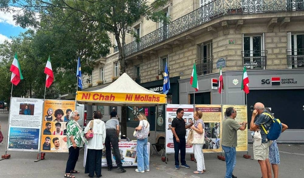 NCRI supporters in Paris, France, set up a book table and photo exhibition condemning the execution of political prisoners on August 5, 2026
