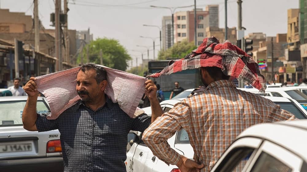 Exhausted commuters in Iran endure oppressive summer heat in gridlocked city streets