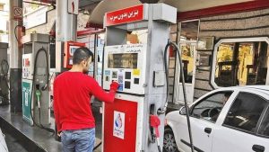 A motorist operates a fuel pump at a gas station in Iran