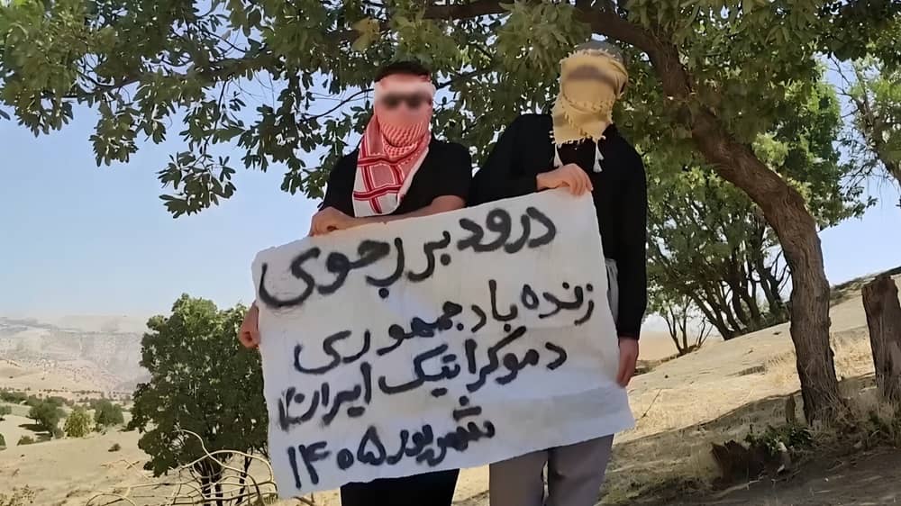 MEK Resistance Units in Kermanshah hold a banner reading “Hail Rajavi. Long live the Democratic Republic of Iran— September 2026