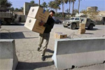 An Iraqi election worker carries ballots into a polling station in the town of Baquba, 50 km (30 miles) north of Baghdad, December 14, 2005. An Iraqi election worker carries ballots into a polling station in the town of Baquba, 50 km (30 miles) north of Baghdad, December 14, 2005.