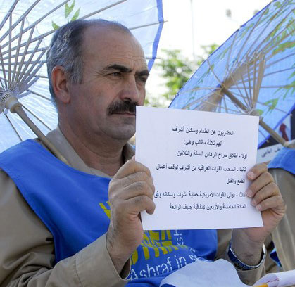 A man from Camp Ashraf holds a sign that states their demands as they go on a hunger strike during a protest against Iraqi forces in Camp Ashraf, north of Baghdad August 24, 2009. They will be on the hunger strike until the Iraqi government agree to their demands, which are, releasing 36 prisoners captured by Iraqi forces, the withdrawal of Iraqi forces and the addition of U.S. forces to the camp. A man from Camp Ashraf holds a sign that states their demands as they go on a hunger strike during a protest against Iraqi forces in Camp Ashraf, north of Baghdad August 24, 2009. They will be on the hunger strike until the Iraqi government agree to their demands, which are, releasing 36 prisoners captured by Iraqi forces, the withdrawal of Iraqi forces and the addition of U.S. forces to the camp.