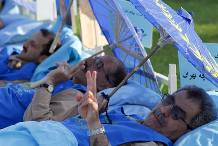 Men from Camp Ashraf flash victory signs as they go on a hunger strike during a protest against Iraqi forces in Camp Ashraf, north of Baghdad August 24, 2009. They will be on the hunger strike until the Iraqi government agree to their demands, which are, releasing 36 prisoners captured by Iraqi forces, the withdrawal of Iraqi forces and the addition of U.S. forces to the camp. Men from Camp Ashraf flash victory signs as they go on a hunger strike during a protest against Iraqi forces in Camp Ashraf, north of Baghdad August 24, 2009. They will be on the hunger strike until the Iraqi government agree to their demands, which are, releasing 36 prisoners captured by Iraqi forces, the withdrawal of Iraqi forces and the addition of U.S. forces to the camp.