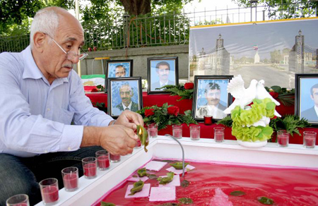 A Demonstrator lights candles to commemorate Iranians killed during the July 28 raid on Camp Ashraf. A Demonstrator lights candles to commemorate Iranians killed during the July 28 raid on Camp Ashraf.