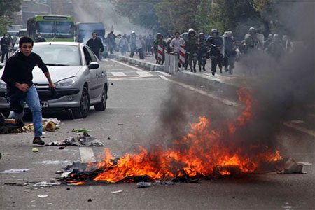 A man running away from the State Security Forces in an anti-regime protest in Tehran, Iran, Wednesday, Nov. 4, 2009. A man running away from the State Security Forces in an anti-regime protest in Tehran, Iran, Wednesday, Nov. 4, 2009.