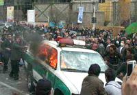 Police car set on fire by angry protesters in Tehran during Ashura day File Photo