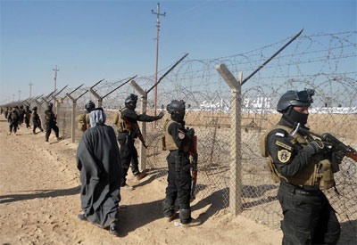 Iraqi forces stand guard outside Camp Ashraf, home to exiled Iranian opposition members. (Dec. 9, 2011) Iraqi forces stand guard outside Camp Ashraf, home to exiled Iranian opposition members. (Dec. 9, 2011)