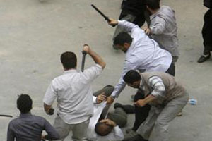 plain-clothes agents of Iranian regime beating a protester in 2009
