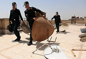 File photo: Police round up satellite dishes in Karaj File photo: Police round up satellite dishes in Karaj